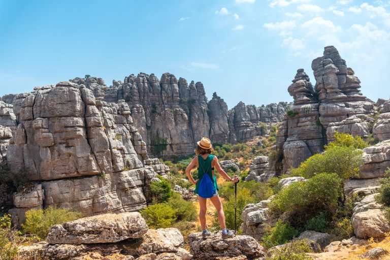 back-view-of-a-woman-standing-on-the-rock-and-looking-at-the-landscape-of-torcal-de-antequera-2